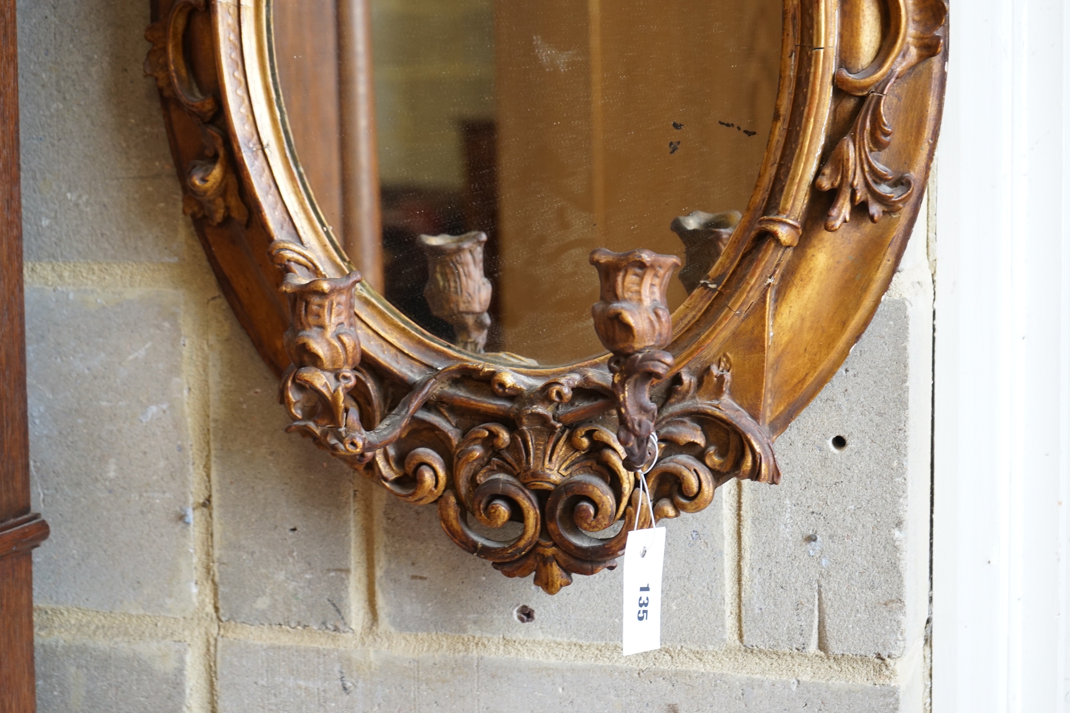 A Victorian giltwood and gesso oval girandole, width 48cm, height 72cm